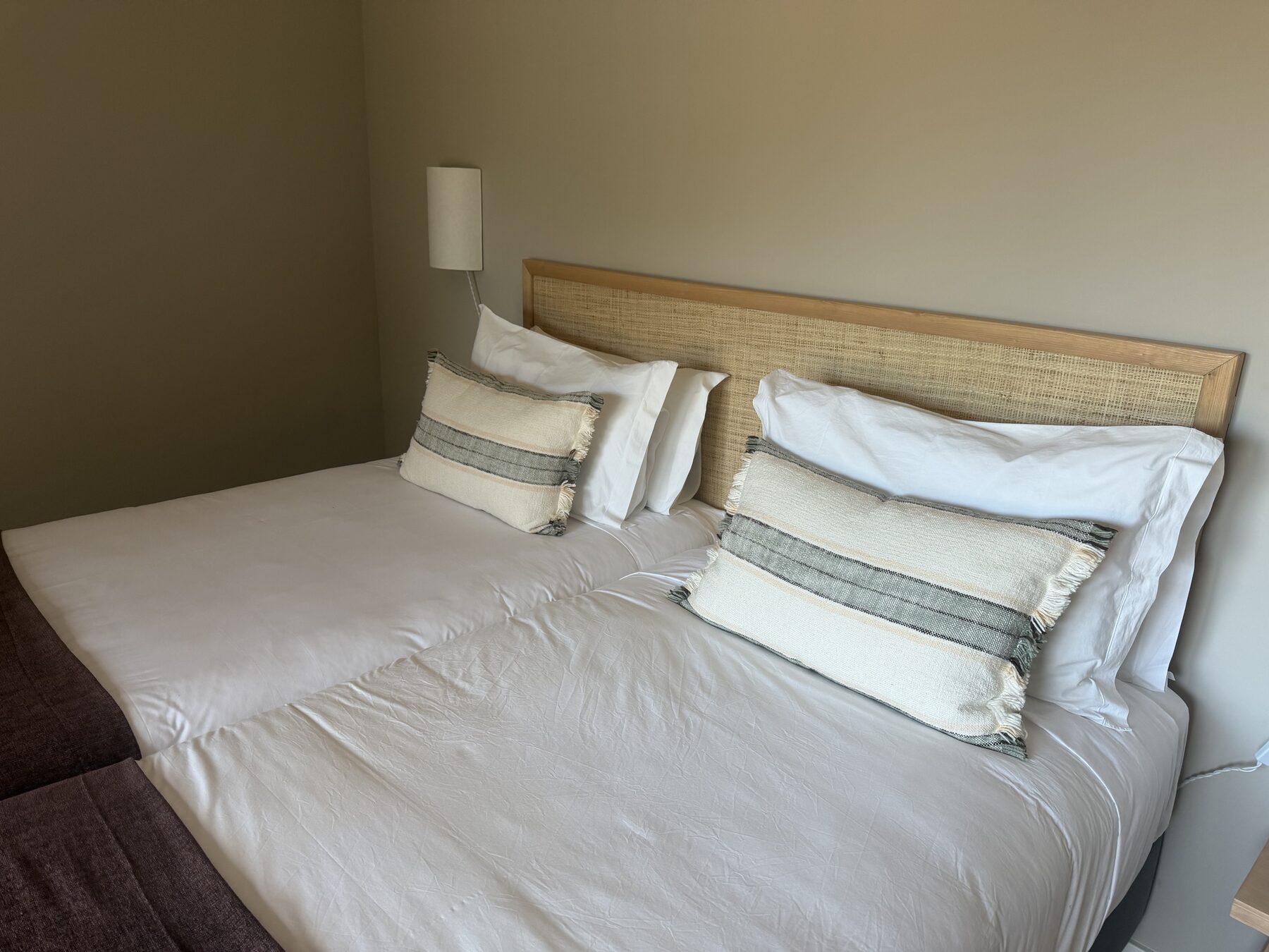 A quiet guest bedroom in earthy linen