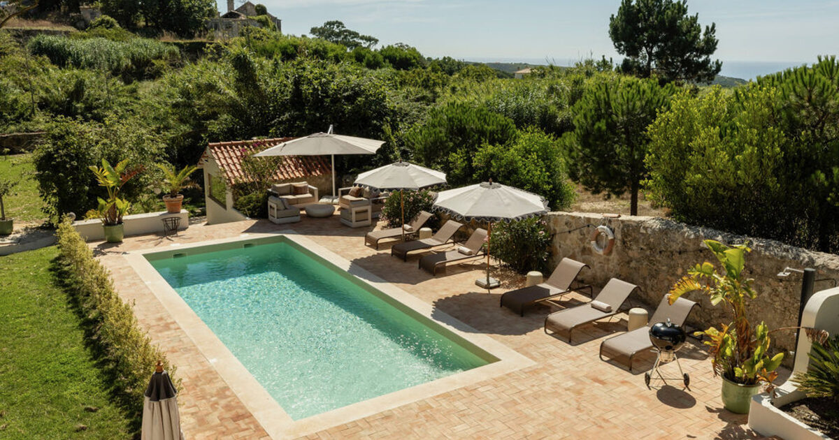 The pool and terrace in the garden at Casa Pavão, Sintra