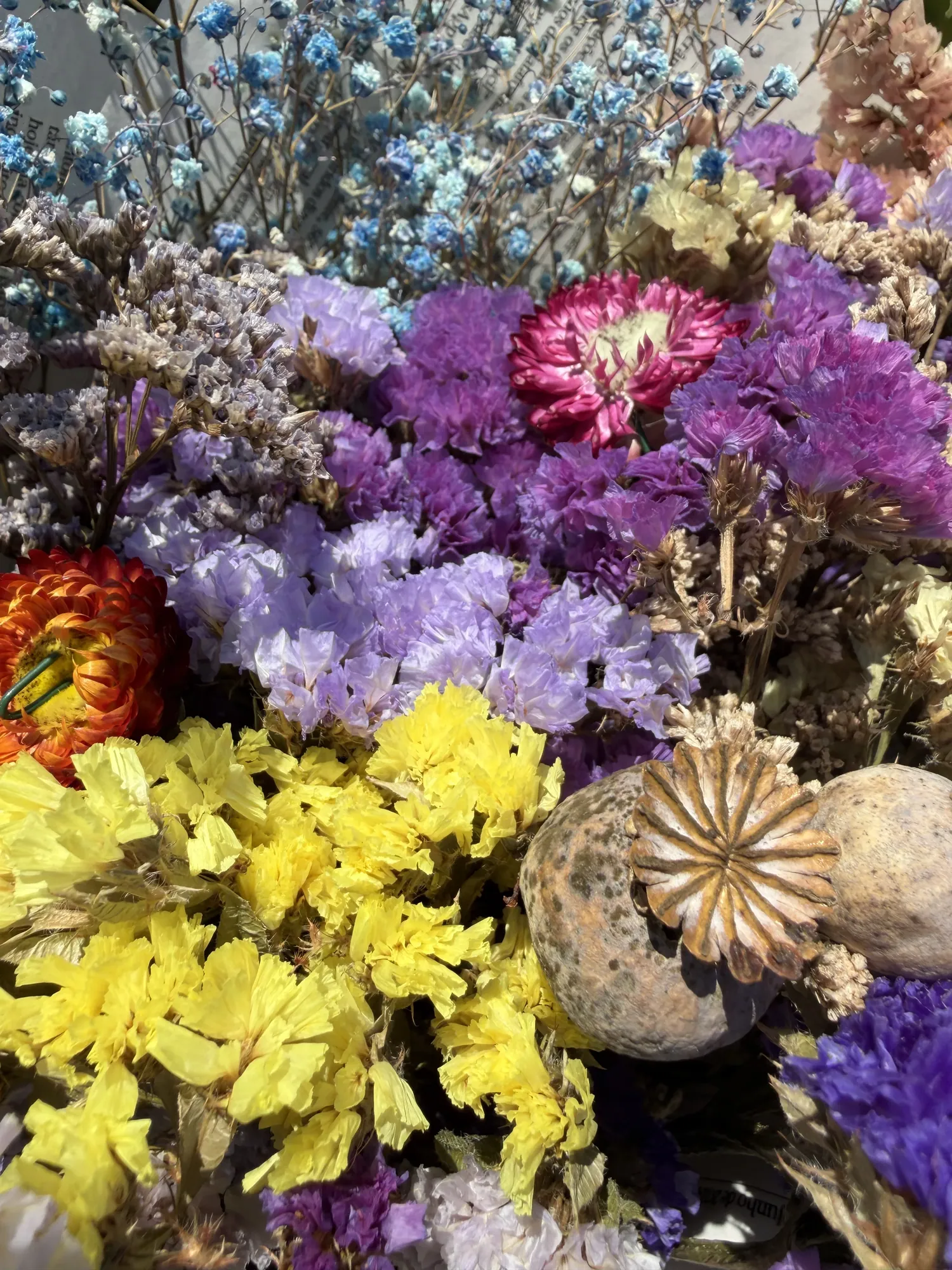 A bouquet of dried flowers in yellow, purple and blue