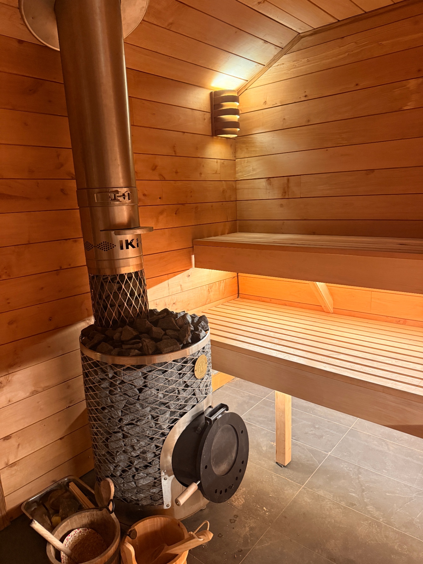 Wood-fired Finnish sauna interior with IKI stove